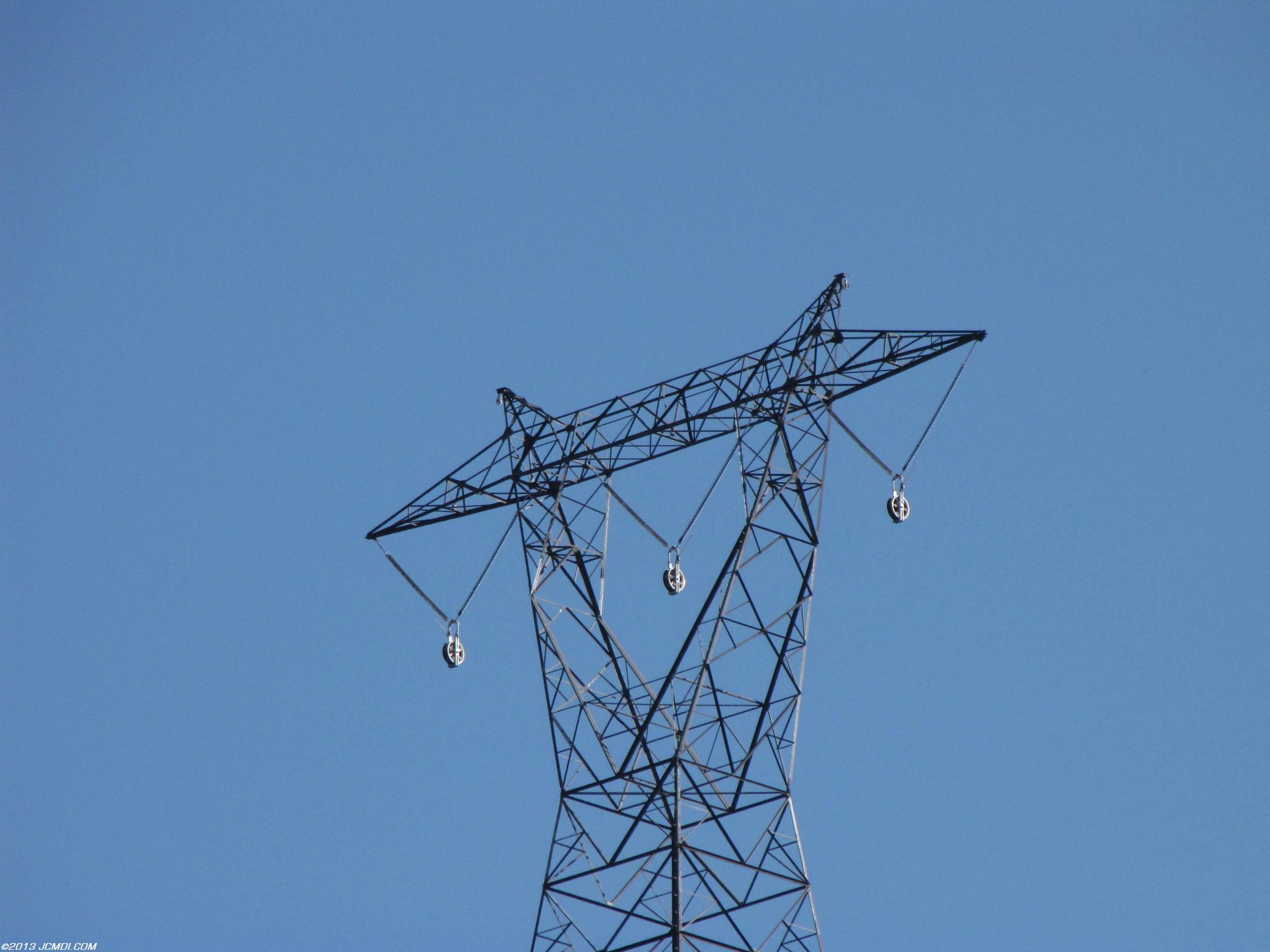High voltage tower with temporary pulleys for cable pulling